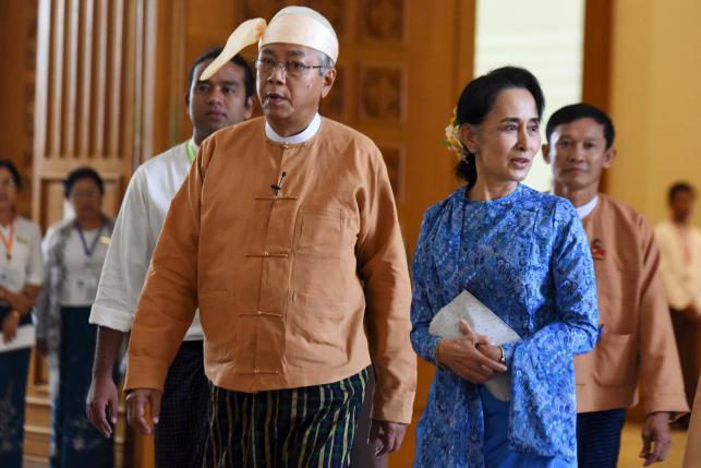 Myanmar's new president Htin Kyaw (L) and National League for Democracy party leader Aung San Suu Kyi arrives to parliament in Naypyitaw March 30, 2016. REUTERS/Stringer